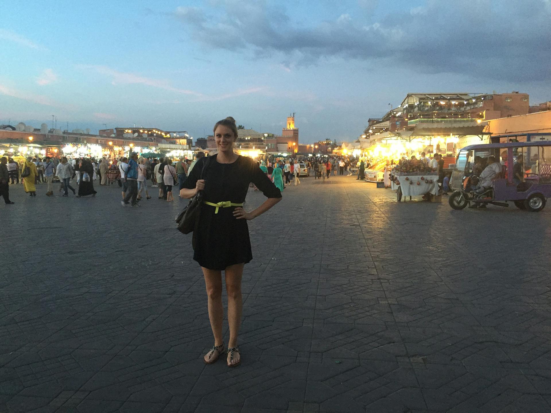 Amanda standing in front of a busy outdoor market in Marrakesh